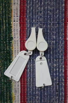 pair of white whistles on a colorful background flat lay