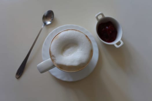 cup of cappuccino coffee with milk foam in the morning overhead shot