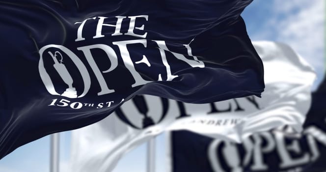 St Andrews, Scotland, June 2022: Three flags with the logo of the 150th The Open Golf Championship are waving in the wind. The Open is a golf tournament to be played 14–17 July in St Andrews, Scotland
