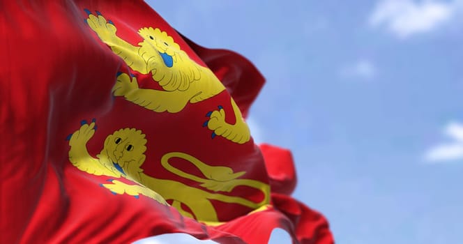 The flag of Normandy region waving in the wind on a clear day. Normandy is the northwesternmost of the eighteen regions of France