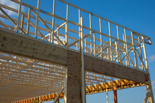 building under construction wood structure beams roof planks house development wood frame