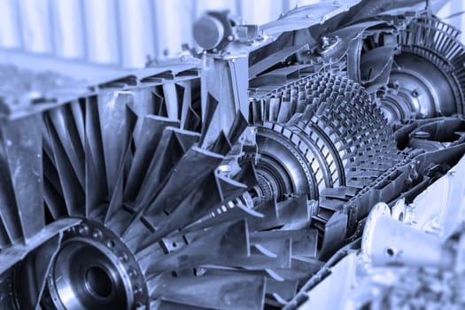 Oblique view  of jet engine cross section with a blue tint. Horizontally.