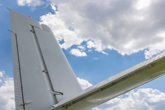 Travel concept of back wing of an airliner . Blue sky is in the background.
