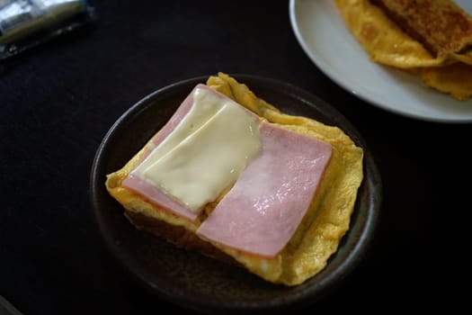 Sandwiches with egg, ham and toast cheese fried in dish