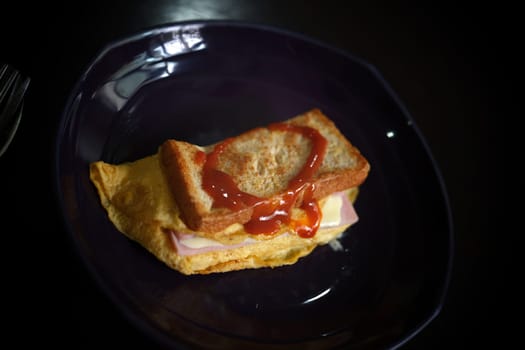 Sandwiches with egg, ham and toast cheese fried in dish