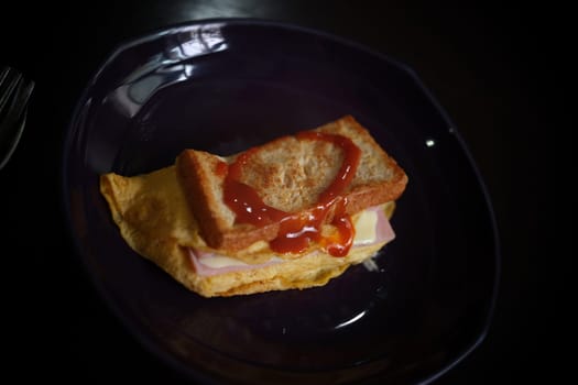 Sandwiches with egg, ham and toast cheese fried in dish