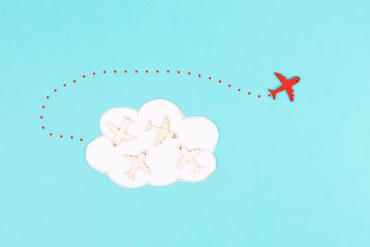 Group of airplanes flying in a cloud, red plane thinks different and takes the opposite direction, against the stream symbolic, courage and winner concept