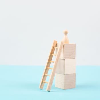 Man is standing next to a ladder, climbing up in career, having a goal, brainstorming for ideas, success strategy, taking a challenge, business concept