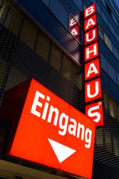 Illuminated advertising of the DIY chain Bauhaus AG on the facade of the DIY store in downtown Berlin