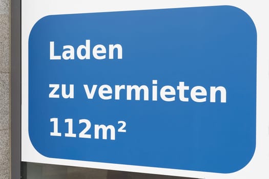 Sign on store window in Germany saying Laden zu vermieten. Translation: store for rent