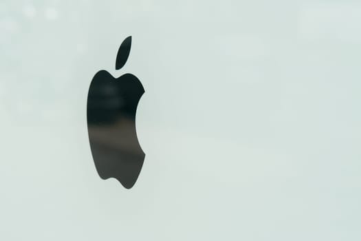 Logo of Apple company on a dirty shop window in downtown Berlin