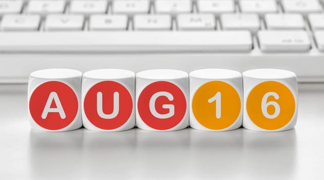 Letter dice in front of a keyboard - August 16