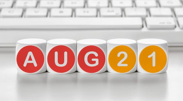 Letter dice in front of a keyboard - August 21