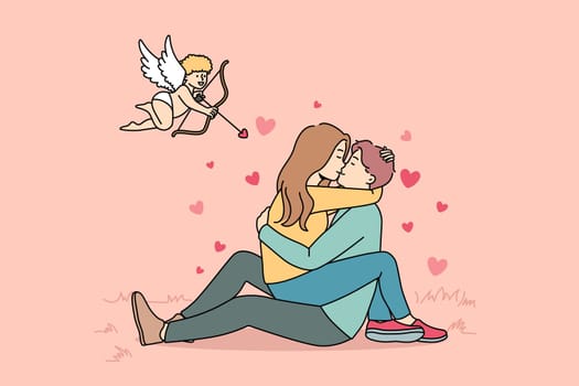 Cupid shooting with arrows in to happy couple kissing. Woman sitting on man hugging and cuddling. Love and relationship. Vector illustration.