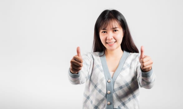 Happy woman smile showing finger thumbs up, Portrait Asian beautiful young female successful like finger gesture, OK sign to agree studio shot isolated on white background with copy space
