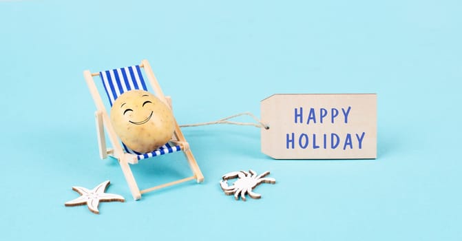 Potato with a funny face is sitting in lounge chairs, sign with the words happy holiday, greeting card