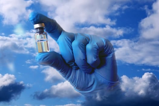 A hand in a blue medical glove sticks out of the clouds and holds out a vial of vaccine. Collage..