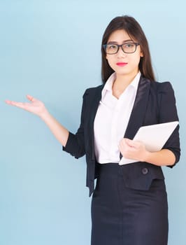 Young women standing in suit holding her digital tablet computor with finger pointing up