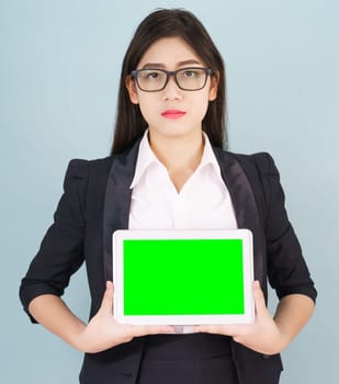 Young asian women in suit holding her digital tablet mock up standing against green background