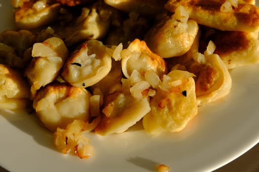Homemade potato dumplings or vereniki pierogi, served with fried onions. Rustic style, comfort eastern europe cuisine.