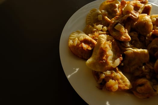 Homemade potato dumplings or vereniki pierogi, served with fried onions. Rustic style, comfort eastern europe cuisine.