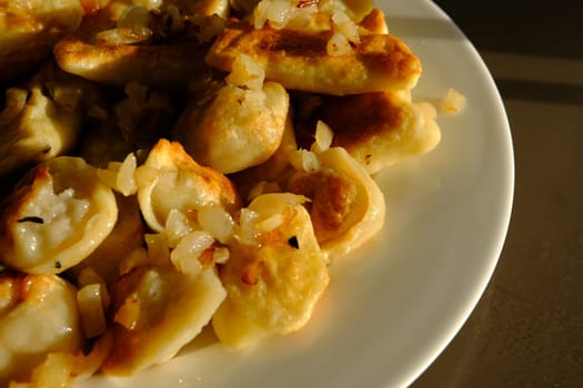 Homemade potato dumplings or vereniki pierogi, served with fried onions. Rustic style, comfort eastern europe cuisine.