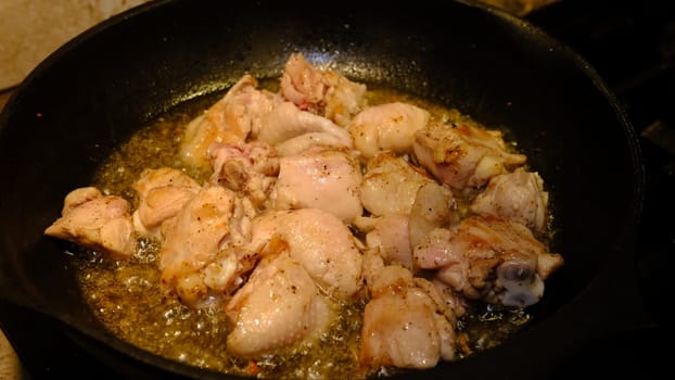 Delicious chicken in frying pan, in sunflower oil.