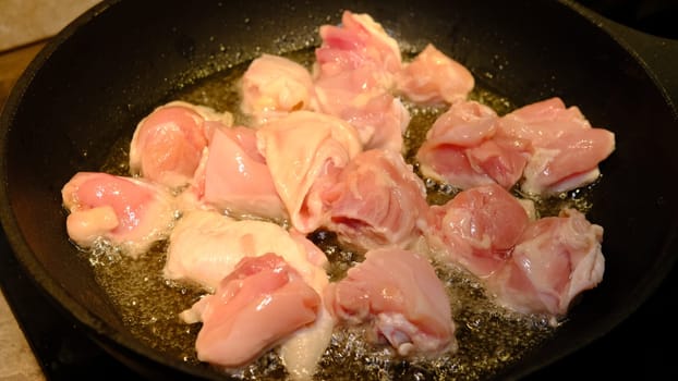 Delicious chicken in frying pan, in sunflower oil.