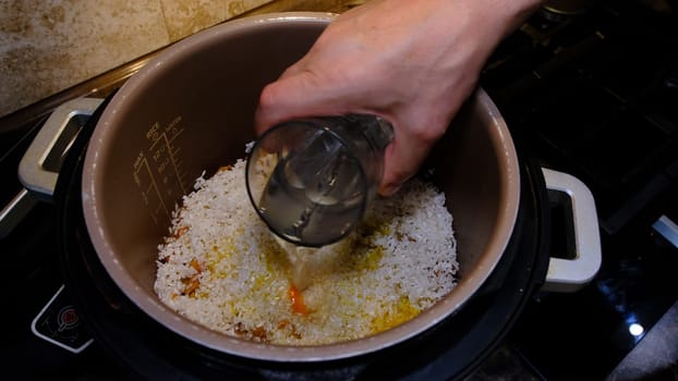 Cooking rice with meat and vegetables in pressure multi cooker step by step. Add water, pilaff.
