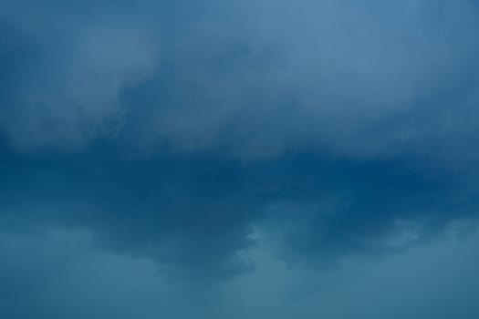 dark storm clouds before rain storm in blue tones.