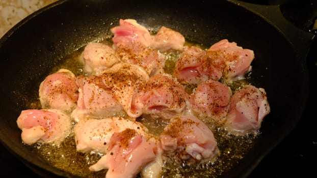 Delicious chicken in frying pan, in sunflower oil.