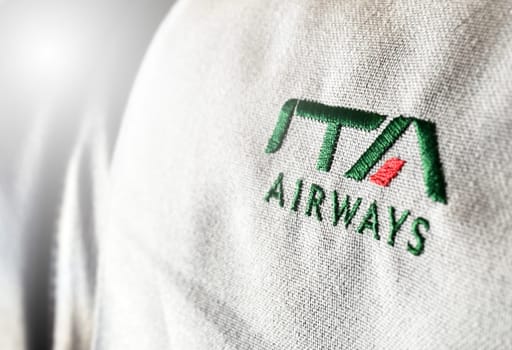 Rome, Italy, July 2022: The logo of the airline ITA Airways sewn on the headrest of an aircraft. ITA Airways is the Italian flag carrier