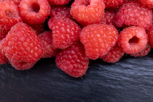 Fresh raspberry summer juicy fruits for a healthy diet. Organic raspberries for a healthy food and life concept.