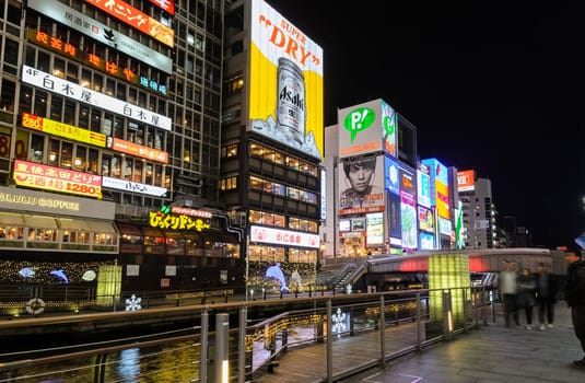 OSAKA, JAPAN - NOVEMBER 23, 2016 : The Asahi Breweries billboard and other illuminated signboards in Dontonbori, Namba area, Osaka, Japan. Dotombori is popular nightlife and entertainment area in Osaka.