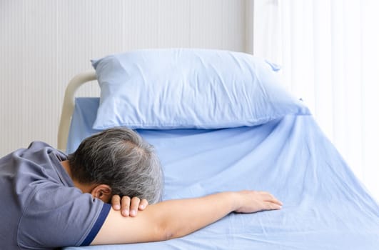 Elderly man feel grief suffer on patient bed for death of loved person