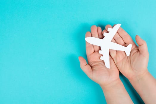 Holding an airplane in the hands, taking a flight, planning a vacation