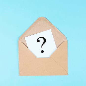 Question mark on a paper in an envelope, education and business concept, searching for answers, thoughts for solving a problem, having doubts