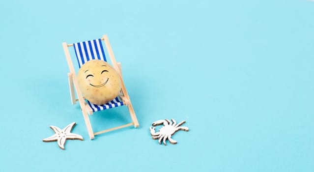Potato with a funny face is sitting in lounge chairs, happy holiday, greeting card