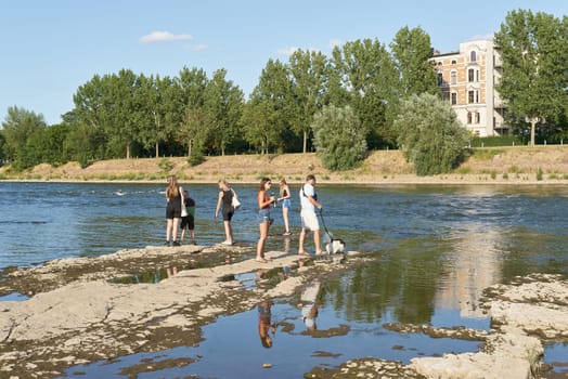 dried up riverbed of river Elbe near Magdeburg in Germany during big drought with some walkers