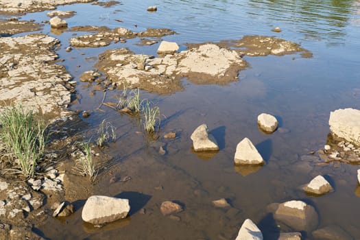 Exposed parched riverbed of the Elbe River in Magdeburg, Germany during severe drought in summer