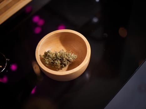 Medical marijuana flower buds. Recreational marijuana strain. Cannabis strain. Weed bud in wood bowl .
