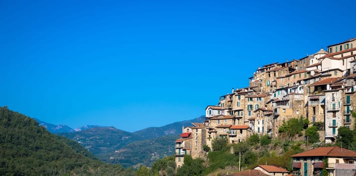 APRICALE, ITALY - CIRCA AUGUST 2020: traditional old village made of stones located in Italian Liguria region  with blue sky and copyspace