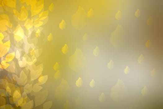 Abstract bright gradient yellow gold bokeh autumn background texture with leaves and sun lights. Indian summer. Space for your design. Beautiful yellow illustration.