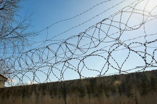 Barbed wire on a blue sky background. High quality photo