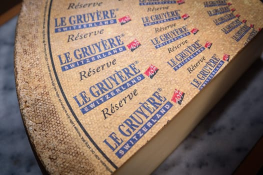 July 11 2022, Lyon, France : Switzerland cheese : Le Gruyère Réserve, famous swiss cheese in a cellar on a marbble background