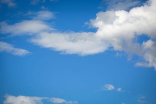 White clouds in the blue sky on a summer day