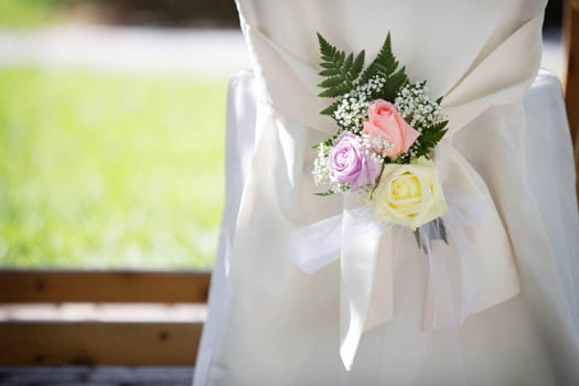 Wedding Chair Cover with Fresh Roses in a Wedding Day