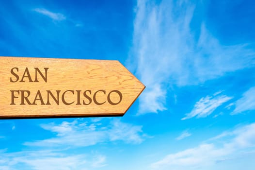 Wooden arrow sign pointing destination SAN FRANCISCO against clear blue sky with copy space available. Travel destination conceptual image