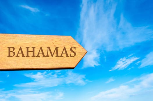 Wooden arrow sign pointing destination BAHAMAS against clear blue sky with copy space available. Travel destination conceptual image