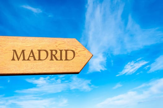Wooden arrow sign pointing destination MADRID, SPAIN against clear blue sky with copy space available. Travel destination conceptual image